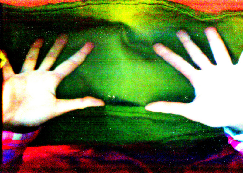 Two hands, blurry with bright green background